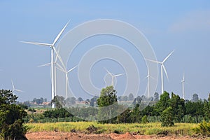 Wind turbine against cloudy blue sky background