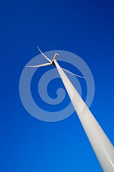 Wind turbine against deep blue sky