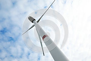 Wind turbine against sky, low angle view. Alternative energy source