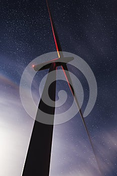 Wind turbine against starry skies