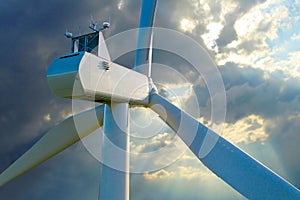 Wind turbine against stormy sky.