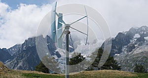 Wind turbine in Alps mountains with Brenva glacier in back. Green, renewable, sustainable energy.