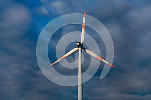 Wind turbine on the background of the blue sky. Clean renewable energy.