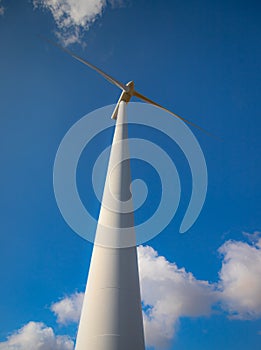 Wind turbine with beautiful blue sky photo