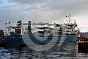 Wind Turbine Blade Sections on a Cargo Vessel at a Small Port