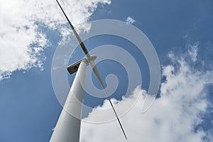 Wind turbine blades against saturated blue sky