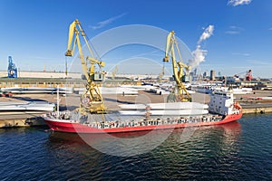 Wind turbine blades are loaded onto a ship