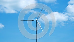 Wind turbine on blue sky background.