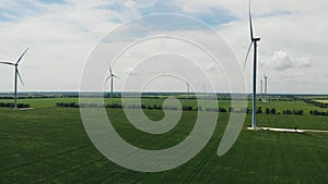 Wind turbine with blue sky and grass field.