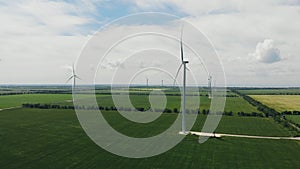 Wind turbine with blue sky and grass field.