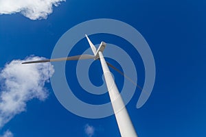 Wind turbine on blue sky photo