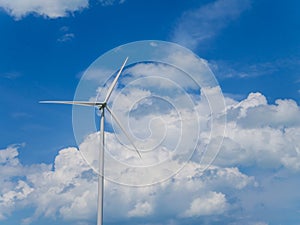 Wind turbine with blue sky and white clouds