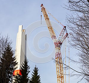 Wind turbine is built with a crane in wind farm