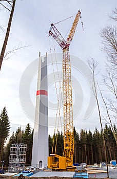 Wind turbine is built with a crane in wind farm