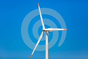 Wind turbine close up. Propeller in blue background. Renewable energy