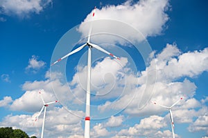 Wind turbine on cloudy blue sky. Alternative energy and electricity source. Global warming. climate change and ecology. Eco power