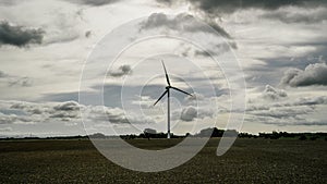 Wind turbine with a cloudy and gray sky photo