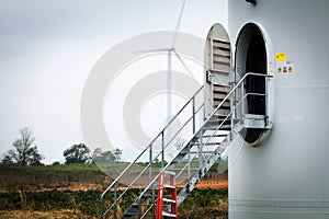 the wind turbine door and a lander with sunset at the solar farm among agriculture of cassava