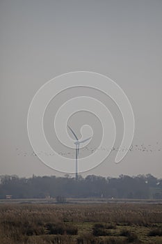 A wind turbine at dusk in February