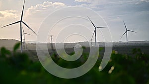 Wind turbine eco farm on beautiful golden hour evening mountain landscape.