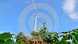 Wind turbine eco farm on beautiful golden hour evening mountain landscape.