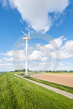 Wind turbine on the edge of a plowed field