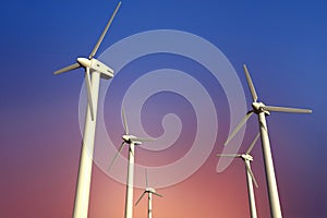 Wind turbine electricity generators on a sunset sky