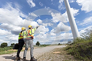 Wind turbine engineer technician male team working service maintenance survey construction site. Eco power energy generator for
