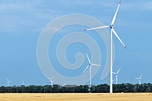 Wind turbine farm above land used for agriculture