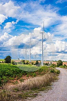 Wind turbine farm in beautiful nature with blue sky blackground, generating electricity