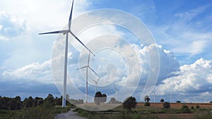 Wind turbine farm in beautiful nature with blue sky blackground, generating electricity