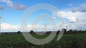 Wind turbine farm in beautiful nature with blue sky blackground, generating electricity