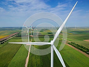 Wind Turbine Farm In Green Field - Green Energy photo