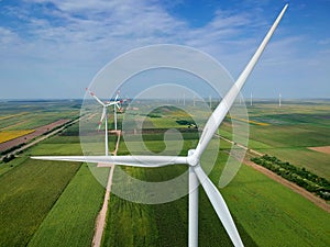 Wind Turbine Farm In Green Field - Green Energy