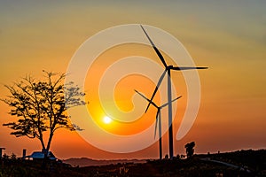 Wind turbine farm over sunset