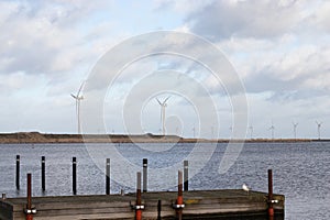 Wind turbine farm power genarator in beautiful nature landscape for production of renewable green energy.