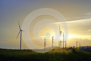 Wind turbine farm with power line and power plant during beautiful sunset, Alternative green energy for protection of nature