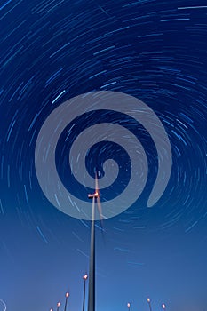 Wind turbine farm and startrails at night