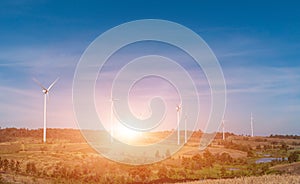 Wind turbine field with blue sky background at sunset