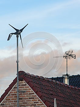 wind turbine fixed on the gable of a house