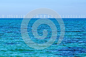 Wind turbine generating electricity on blue sea. Wind-driven generator in Baltic sea, Oresund strait