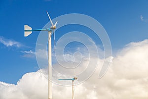 Wind turbine generating electricity on blue sky with clounds,Windmills for electric power ecology concept