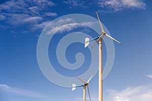 Wind turbine generating electricity on blue sky with clounds,Windmills for electric power ecology concept