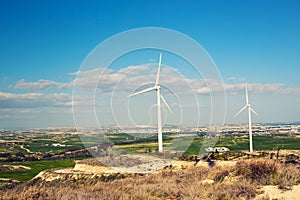 Wind turbine generating electricity with blue sky - energy conservation concept