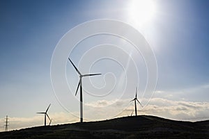 Wind turbine generating electricity with blue sky - energy conservation concept