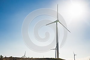 Wind turbine generating electricity with blue sky - energy conservation concept