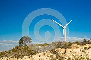 Wind turbine generating electricity with blue sky - energy conservation concept