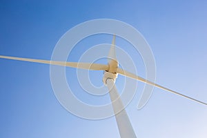 Wind turbine generating electricity with blue sky - energy conservation concept