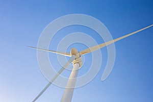 Wind turbine generating electricity with blue sky - energy conservation concept