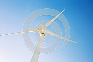 Wind turbine generating electricity with blue sky - energy conservation concept